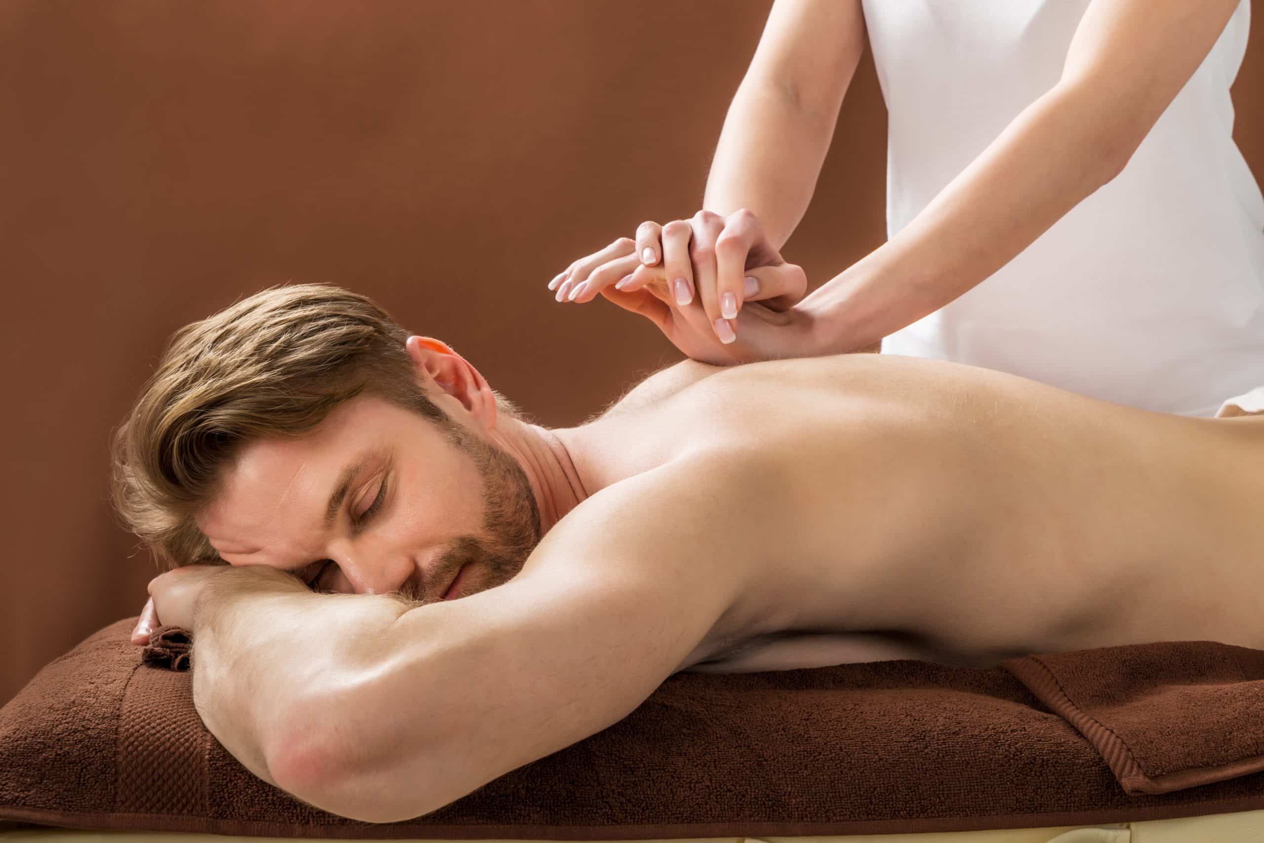 Portrait,Of,A,Young,Man,Receiving,Back,Massage,At,A Sport Massage