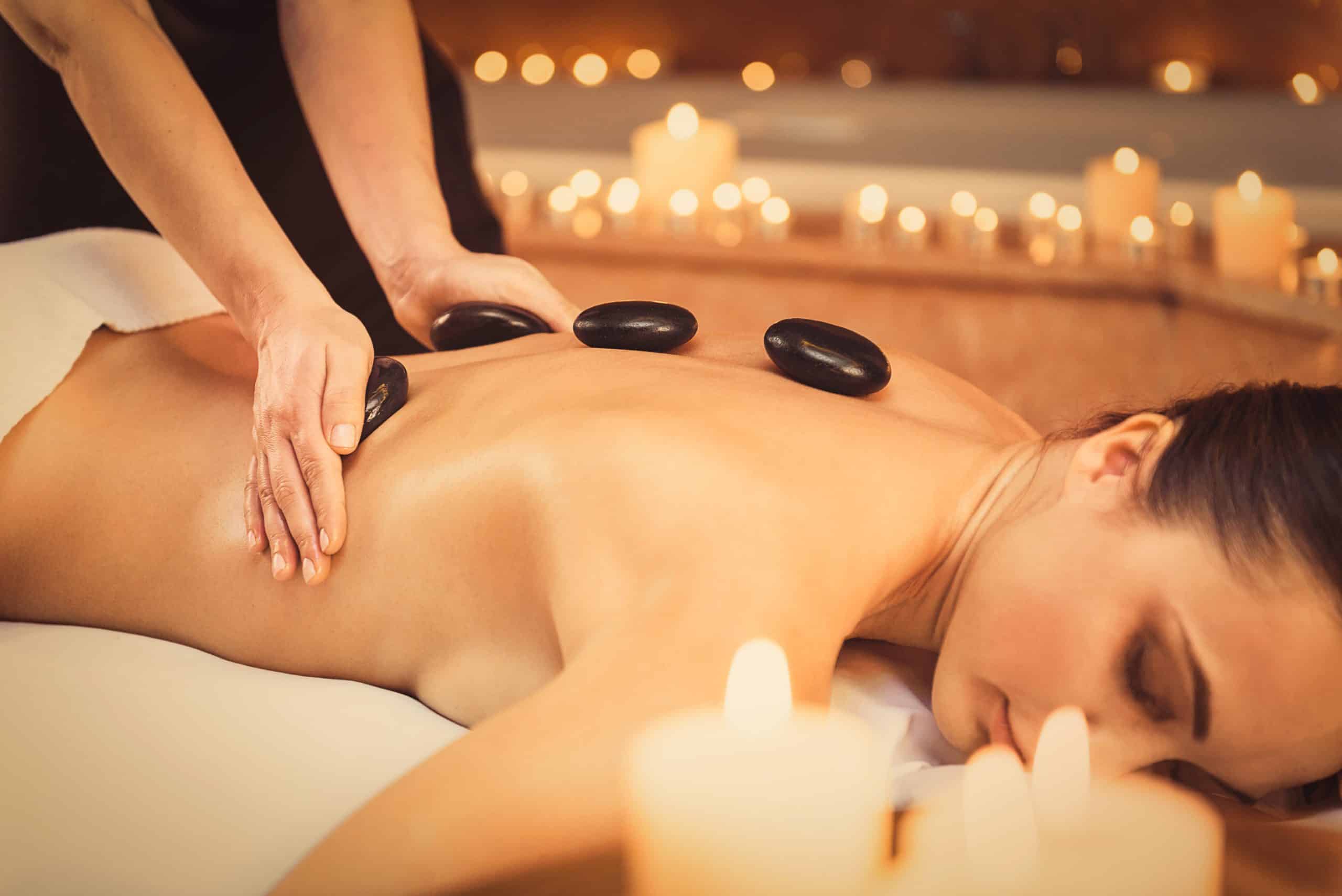 Professional,Beautician,Massaging,Female,Back,By,Stones Hot Stone Massage